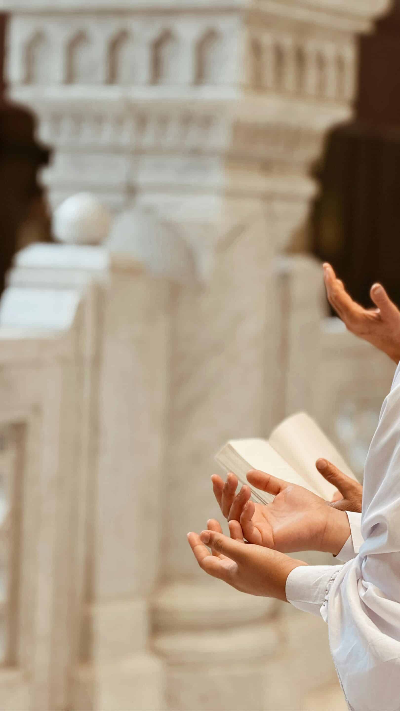 Hands Raised in Prayer Near Ornate Marble Structure reflecting the Methodist vs Catholic Church worship styles.