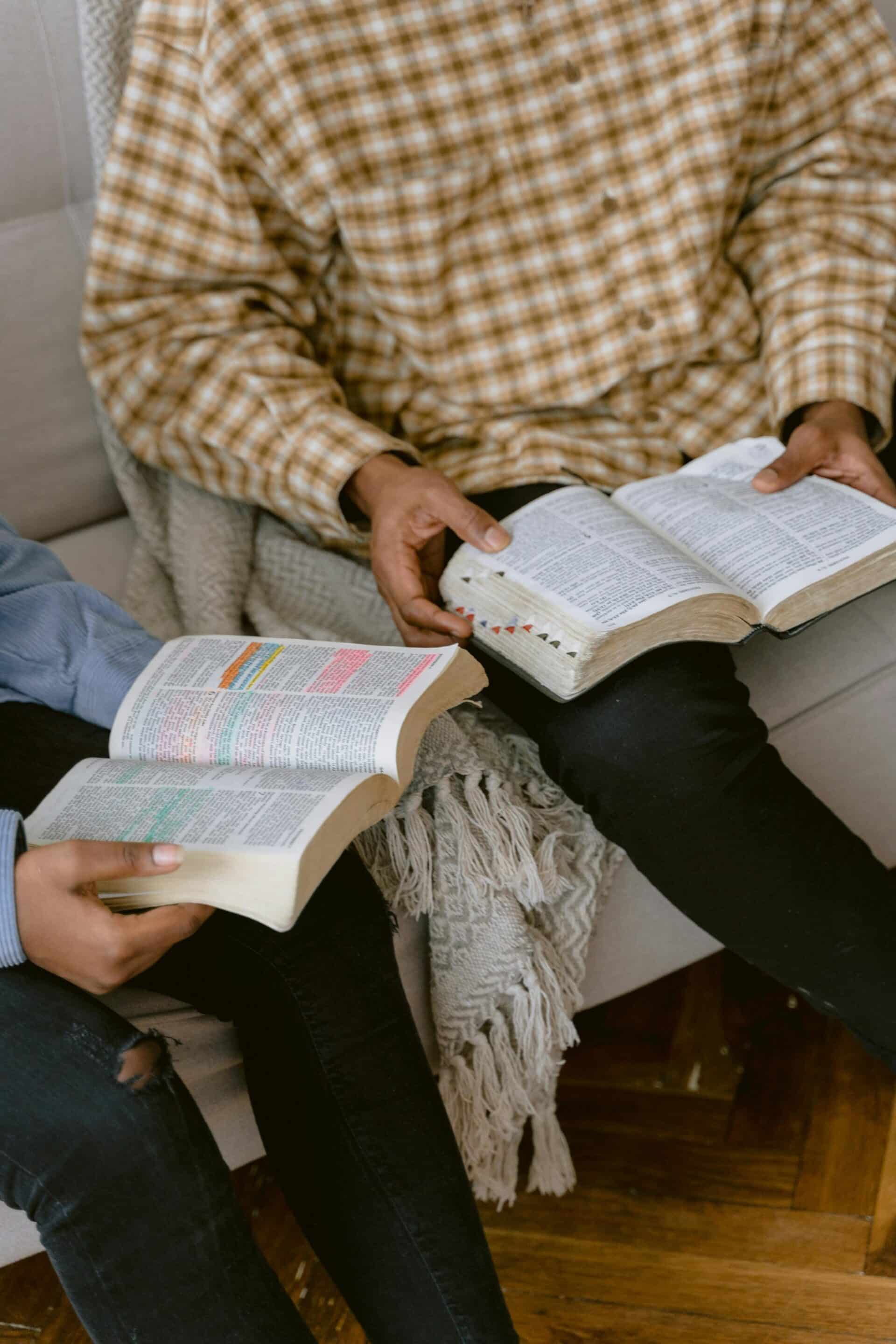 Two People Reading Bible while Sitting on a Sofa reflecting the importance of unity after the United Methodist Church split.
